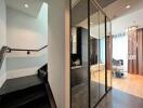 Modern entrance hall with reflective surfaces and elegant staircase