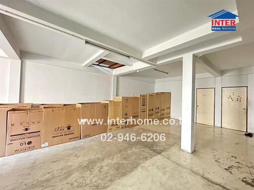 Spacious basement with storage boxes and multiple columns