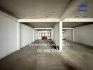 Spacious unfurnished interior of a commercial building with columns