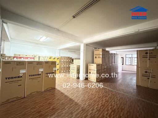 Spacious commercial building interior filled with boxes