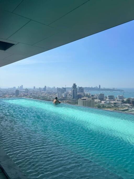 Luxurious rooftop infinity pool overlooking the city skyline and ocean