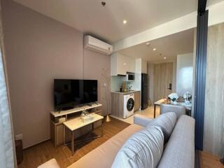 Modern studio apartment interior with combined living, kitchen, and sleeping areas
