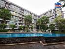 Apartment building with pool and green balconies