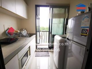 Compact modern kitchen with appliances and balcony access