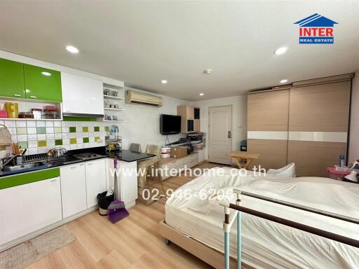 Compact studio apartment with integrated living, kitchen, and sleeping area