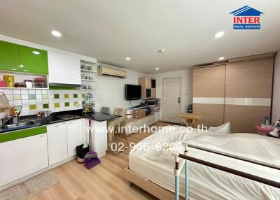 Compact studio apartment with integrated living, kitchen, and sleeping area