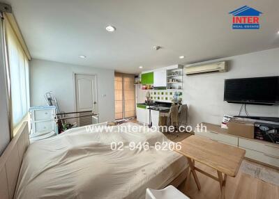 Compact studio apartment with integrated living, kitchen, and sleeping area