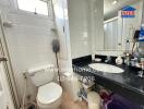 Compact bathroom with white fixtures and natural light