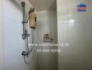 Bathroom interior with wall-mounted shower and water heater