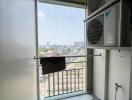 Compact urban balcony with air conditioning units and outdoor view