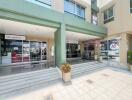 Entrance of a commercial residential building with visible ground floor shops