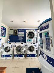 Modern public laundry room with multiple washing machines