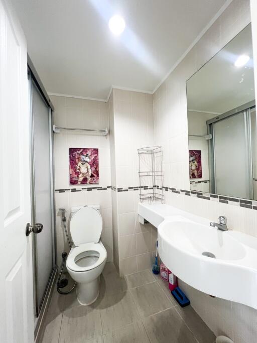 Modern bathroom interior with clean white fixtures and decorative artwork