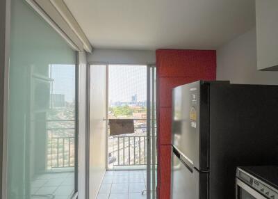 Compact kitchen with modern appliances and balcony access