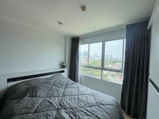 Spacious bedroom with large window and city view