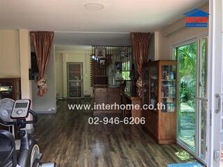 Spacious living room with large windows and garden view