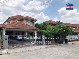 Beautiful single-family home with orange tile roof and landscaped front yard