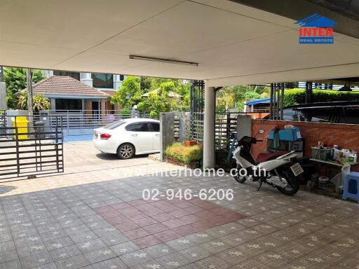 Spacious covered garage area with vehicles and storage space in a residential property