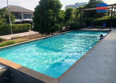 Inviting outdoor swimming pool with adjacent seating area in a residential property