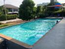 Inviting outdoor swimming pool with adjacent seating area in a residential property