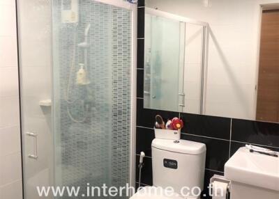 Modern bathroom with glass shower and stylish tiling