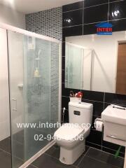 Modern bathroom with glass shower and stylish tiling