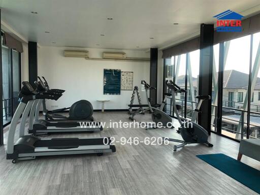 Spacious residential gym with modern equipment and city views