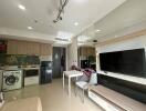 Compact and modern multi-functional living space with integrated kitchen, laundry, and entertainment area