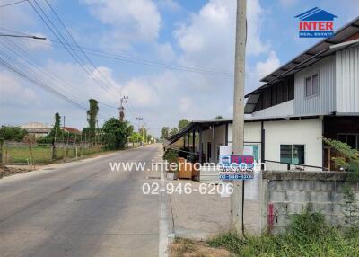 Paved road leading to modern residential homes
