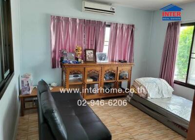Spacious bedroom with comfortable furnishings and large window
