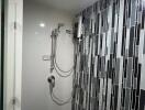 Modern bathroom with wall-mounted shower and stylish black and white tiles