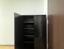 Empty room interior with an open black cabinet