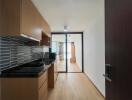 Modern kitchen leading to a well-lit living room