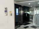 Modern building lobby with checkered floor and glass doors