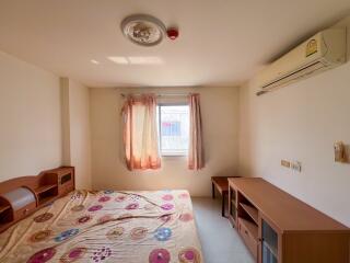 Simple and compact bedroom with ample natural light