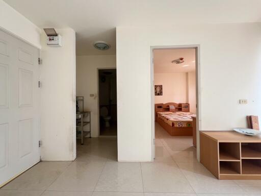 Spacious apartment showing an entryway leading to a bedroom