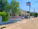 Suburban street view with modern homes and gated entries under clear blue skies