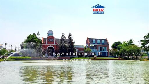 External view of a luxurious waterfront real estate property with a fountain