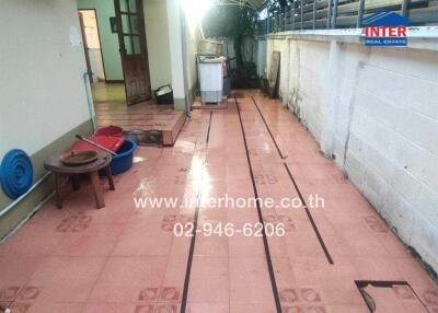 Outdoor patio area with tiled flooring and laundry appliances