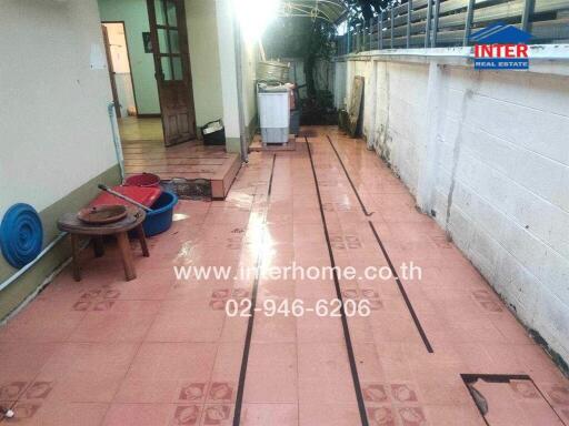 Outdoor patio area with tiled flooring and laundry appliances