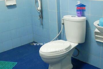 Clean bathroom with blue tiles and white fixtures