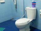 Clean bathroom with blue tiles and white fixtures