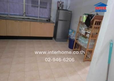 Spacious kitchen with tiled flooring and ample storage
