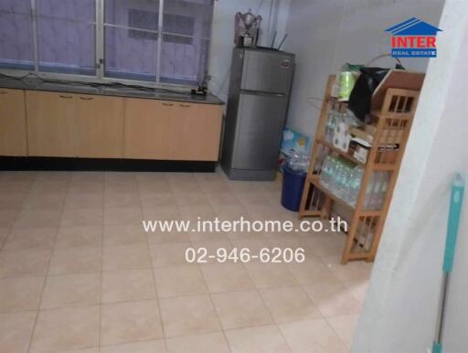 Spacious kitchen with tiled flooring and ample storage