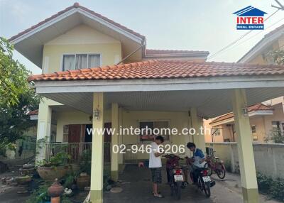 Spacious two-story house with covered carport and tiled roof