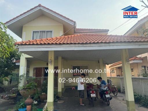 Spacious two-story house with covered carport and tiled roof