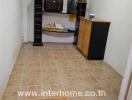 Small office space with tiled flooring and storage furniture