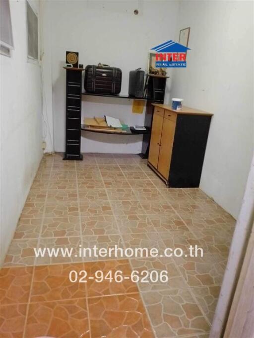 Small office space with tiled flooring and storage furniture