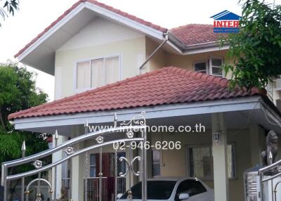 Exterior view of a modern two-story house with a red tiled roof