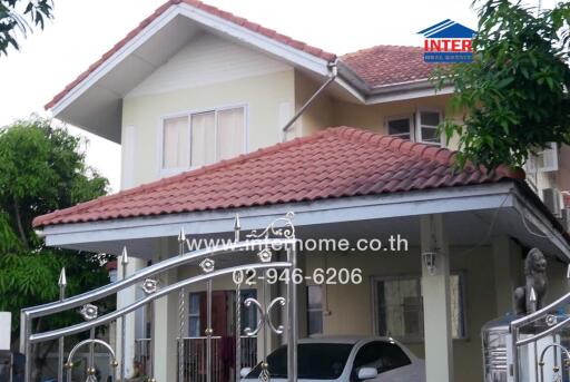 Exterior view of a modern two-story house with a red tiled roof